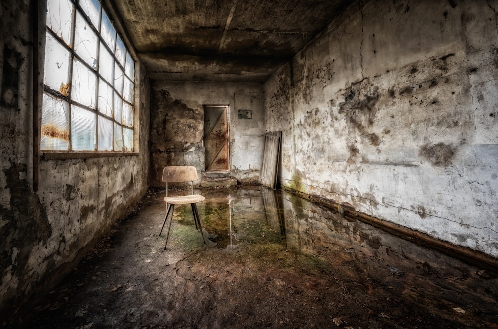 a chair sitting in a room next to a window