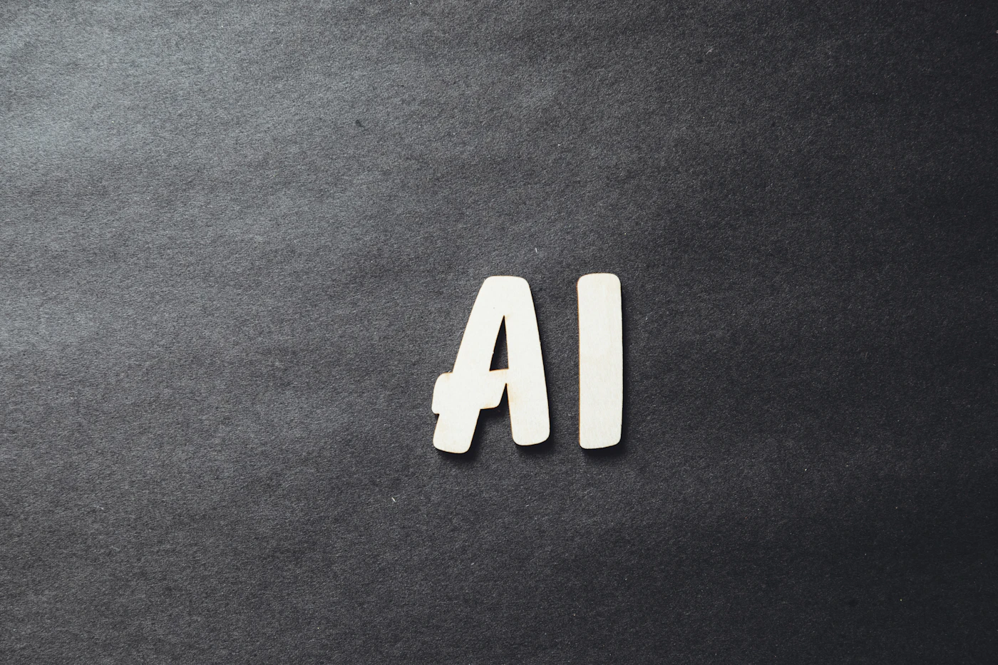 The word ai spelled in white letters on a black surface