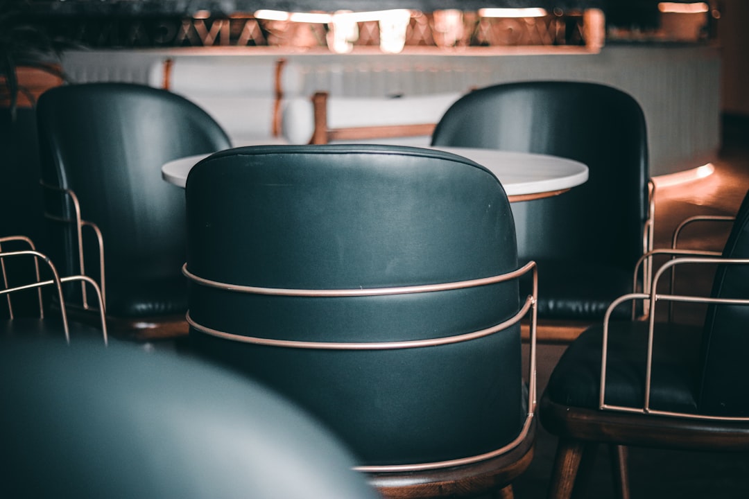 a group of black chairs sitting next to each other,
