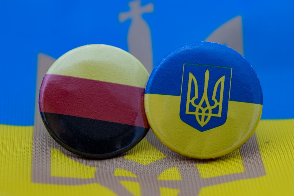 two buttons with the flag of germany and the coat of arms