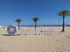 a sign that is sitting in the sand