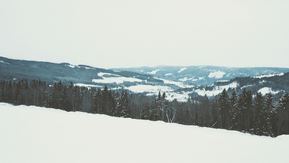 a person riding skis on top of a snow covered slope