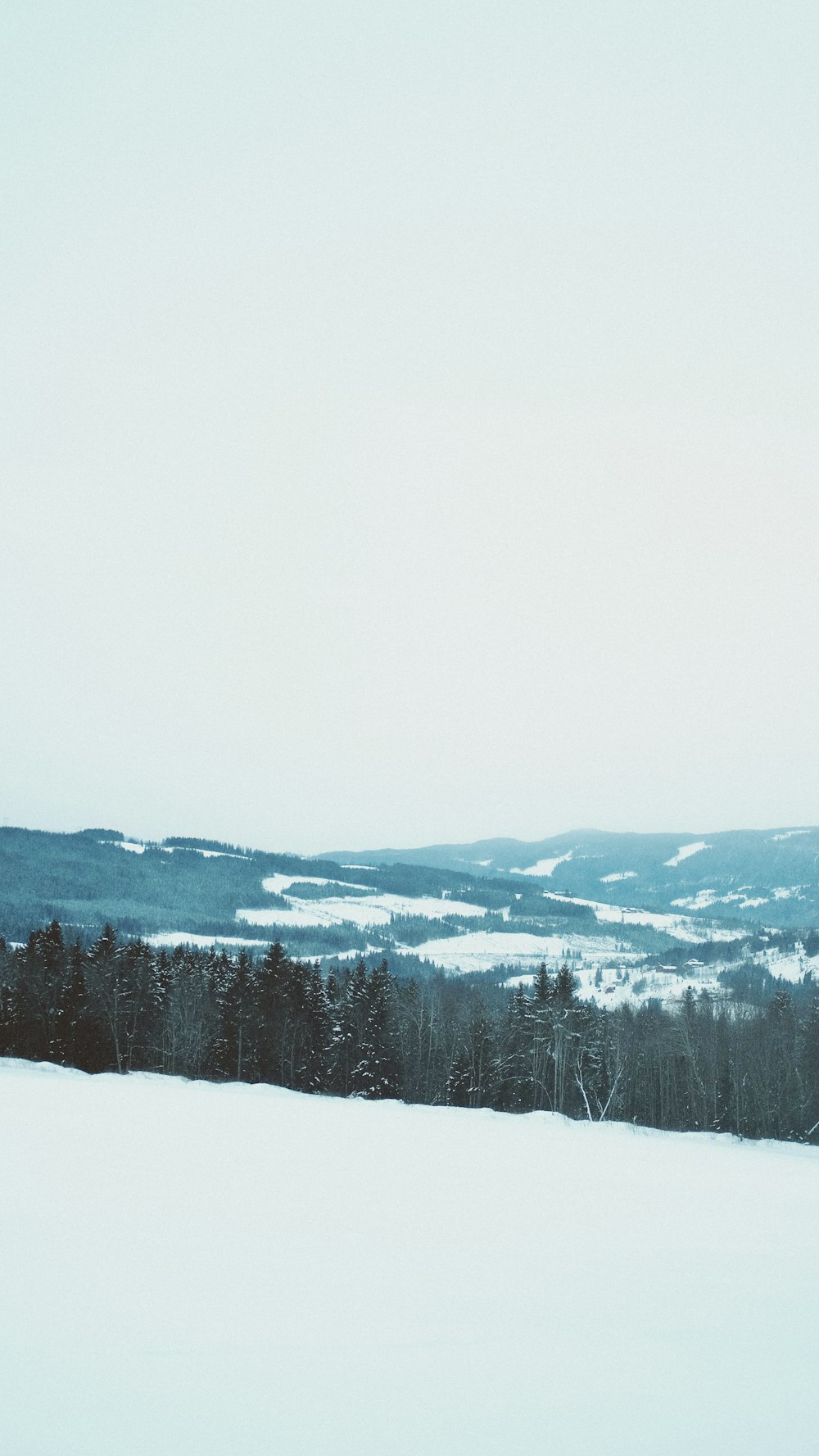 a person riding skis on top of a snow covered slope