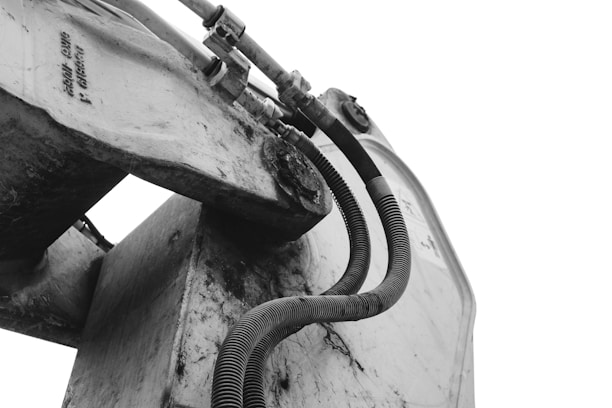 a black and white photo of a boat with a hose attached to it