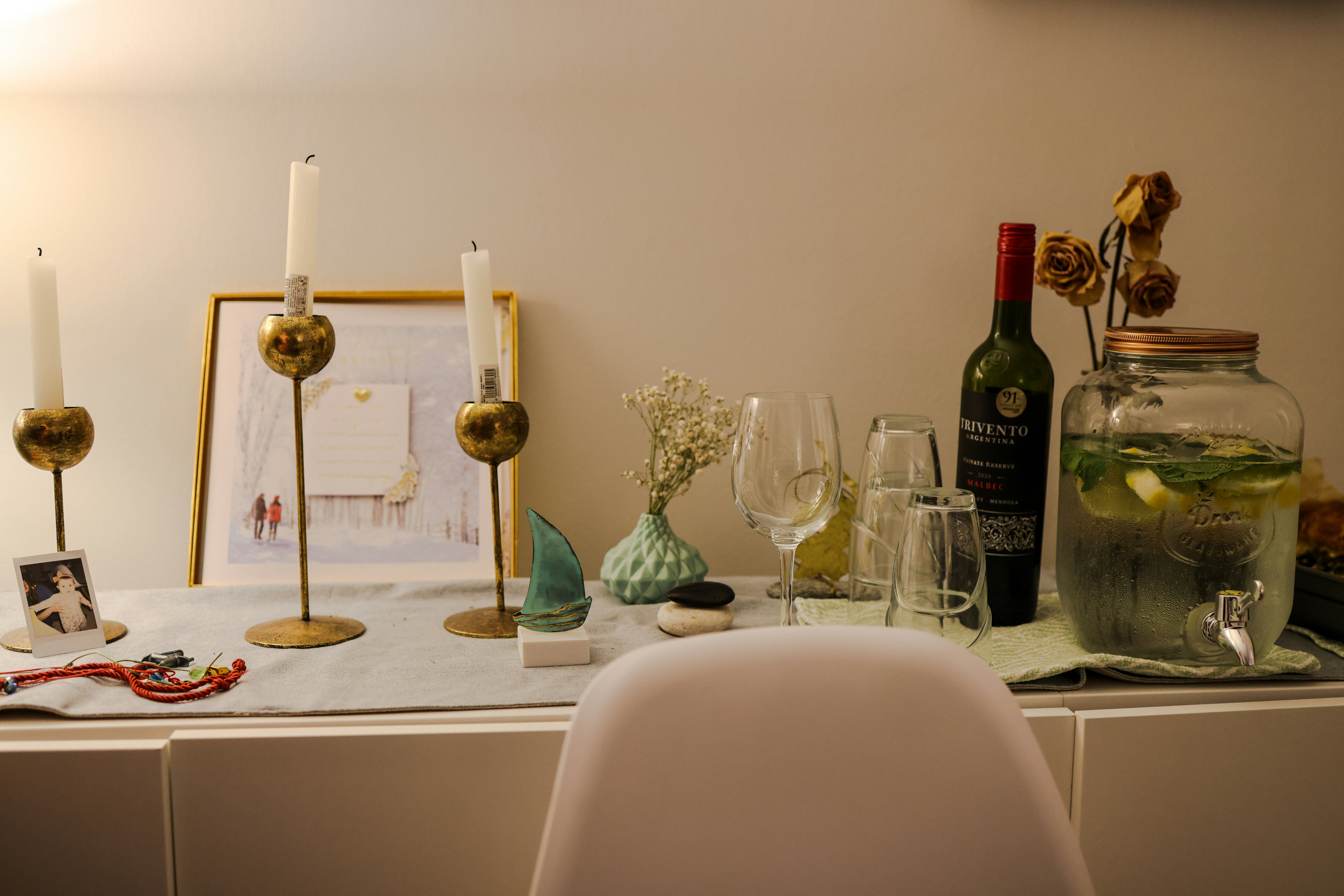 a table topped with wine glasses and a bottle of wine