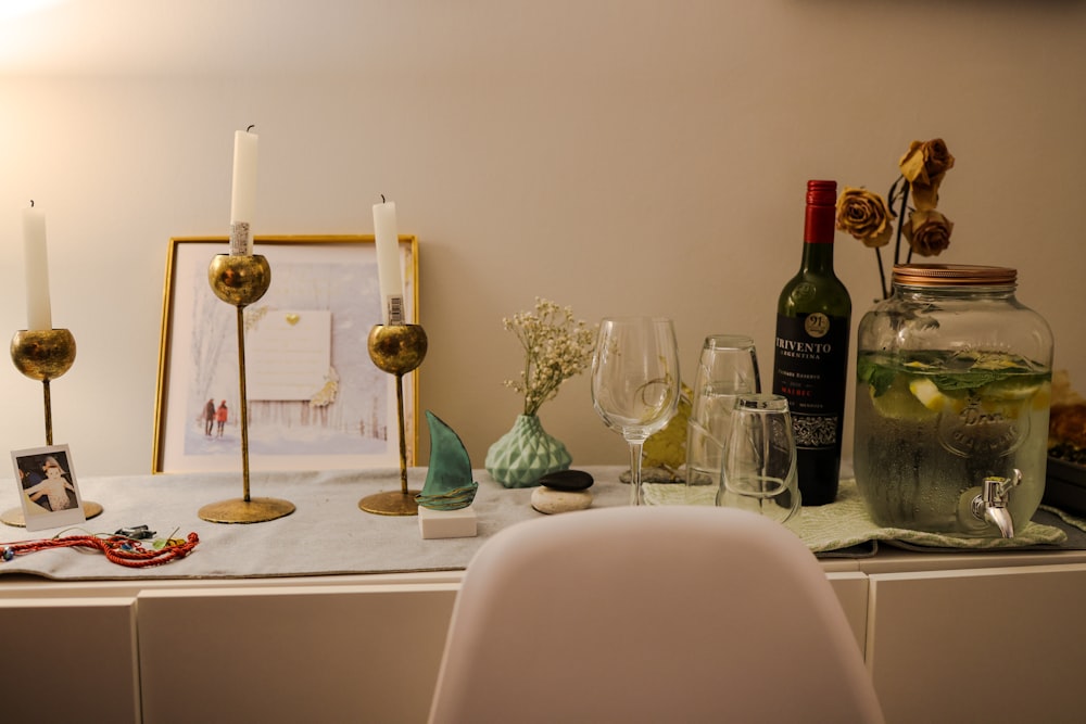 a table topped with wine glasses and a bottle of wine