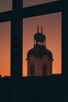 Photographer capturing the clock tower at sunset, highlighting its intricate details.