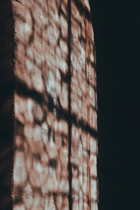 Artistic lighting installation casting warm, cinematic shadows.