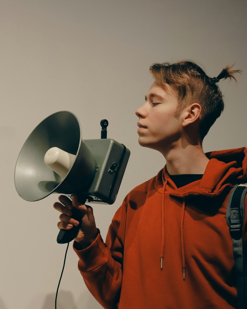 a young man holding a camera and a microphone