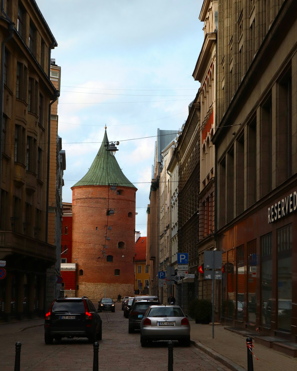 a city street lined with tall brown buildings