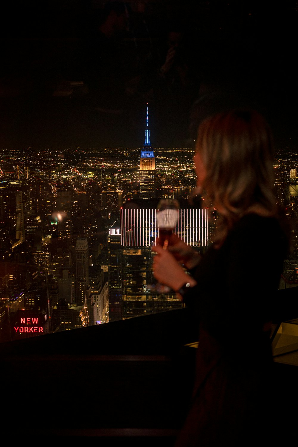 a woman standing on top of a tall building