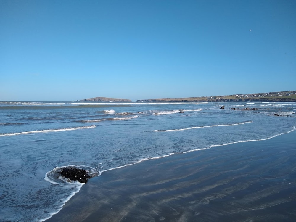 a beach with waves coming in to shore