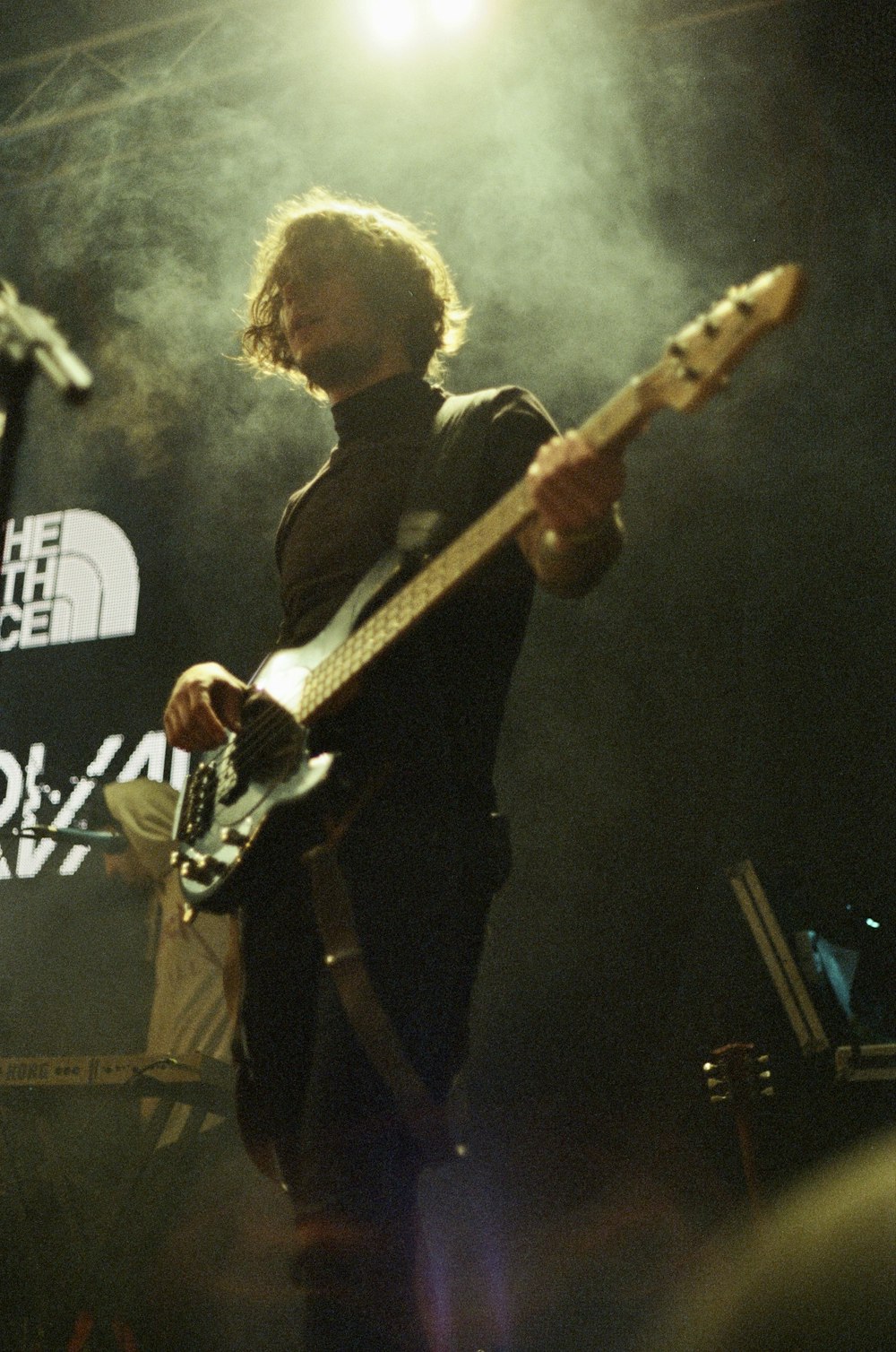 a man playing a guitar on stage at a concert