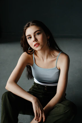 a woman sitting on the floor with her legs crossed