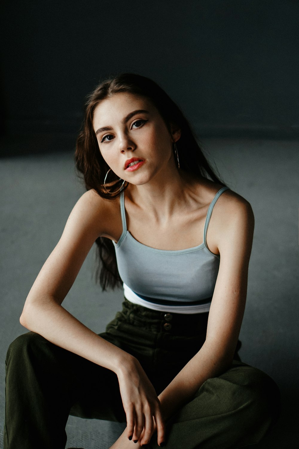 a woman sitting on the floor with her legs crossed