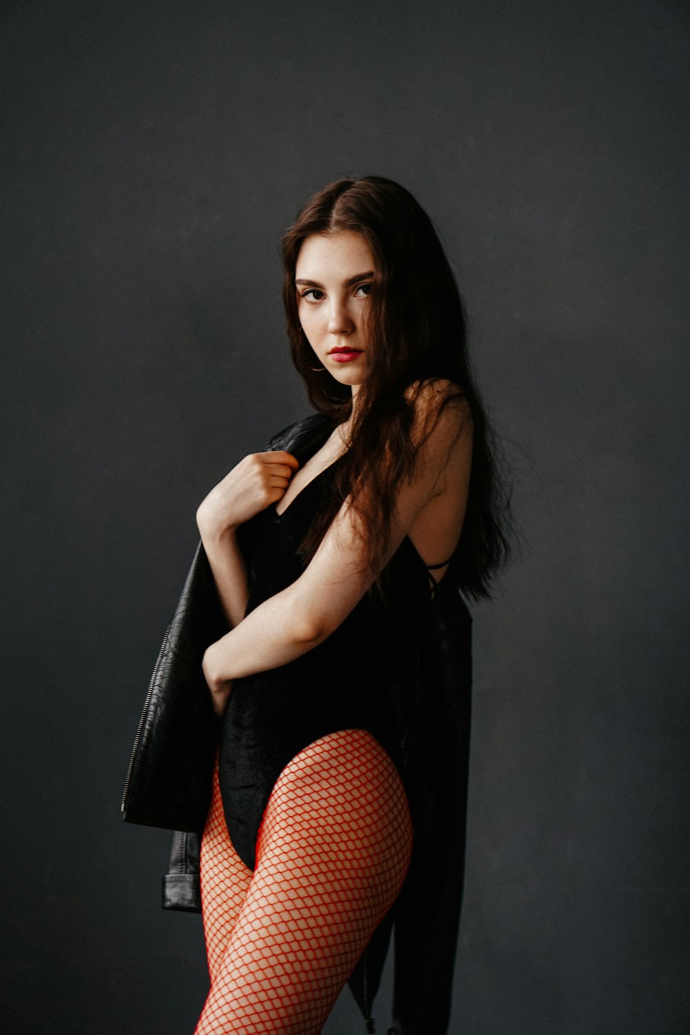 a woman in fishnet stockings and stockings posing for a picture