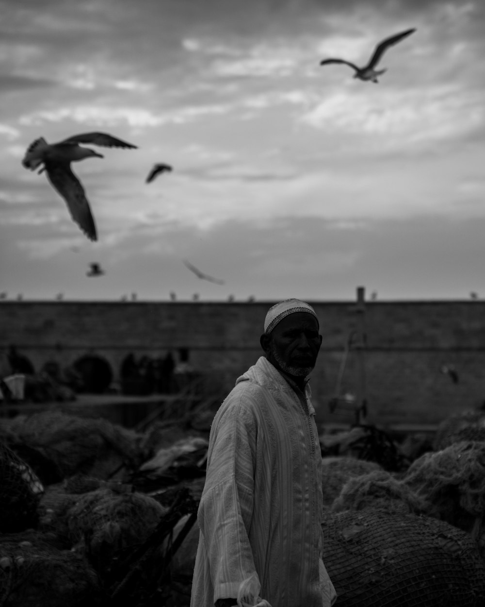 a man standing in front of a flock of birds