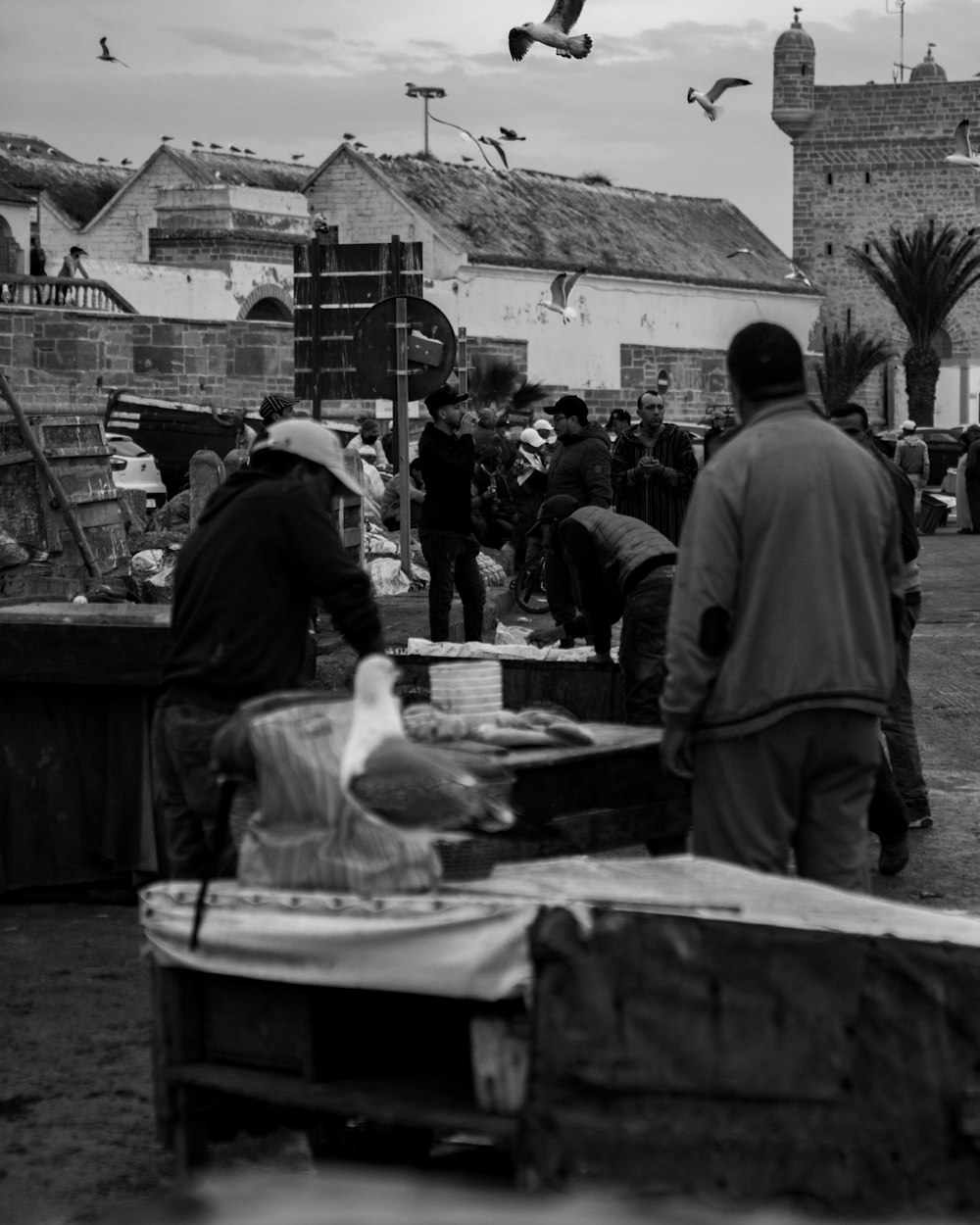 a black and white photo of people at a market