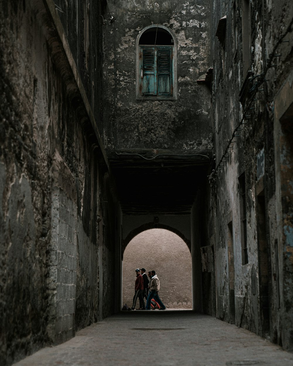 a couple of people that are standing in a tunnel