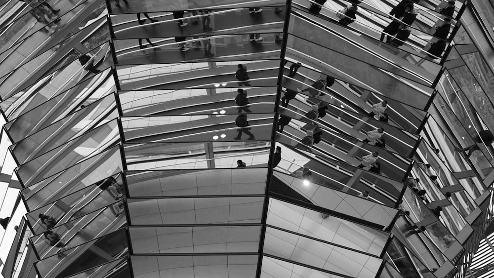 a black and white photo of people walking in a building