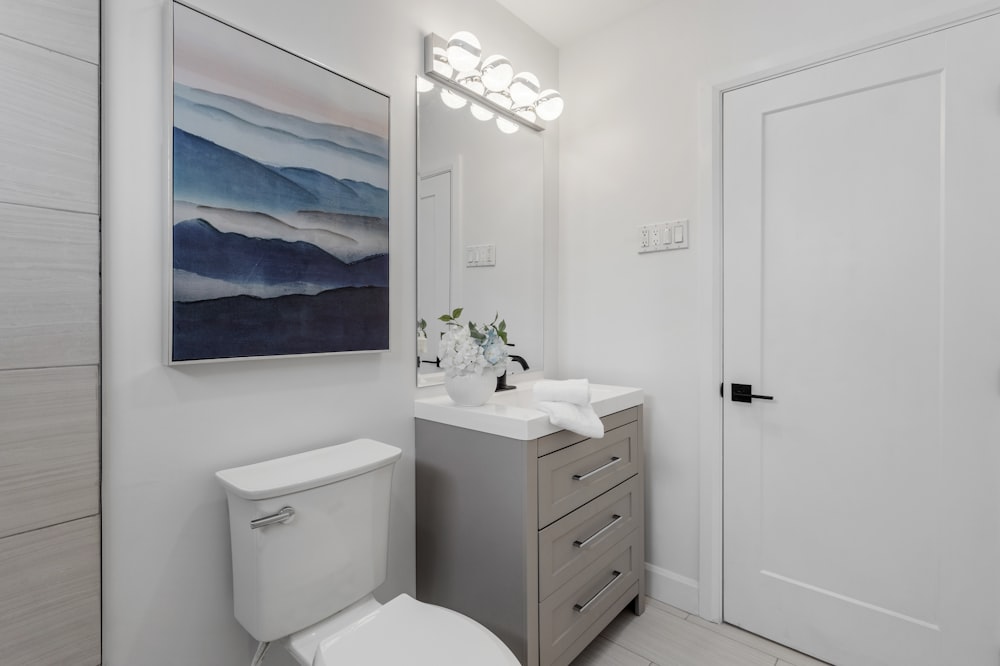 a bathroom with a white toilet sitting next to a white sink