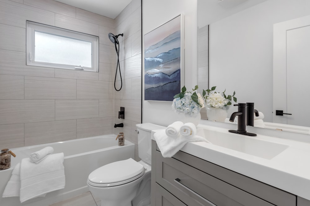 a bathroom with a toilet, sink, and bathtub