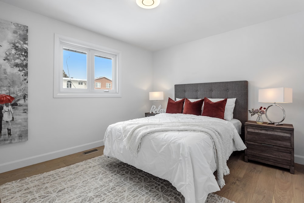 a bedroom with a large bed and a painting on the wall