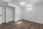 an empty room with white walls and wooden floors