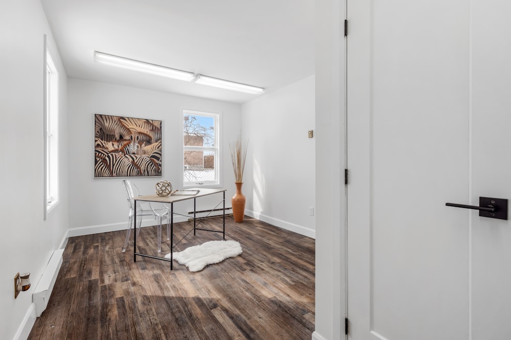 a white room with a table and chairs