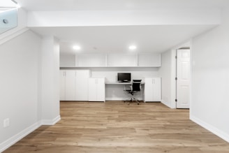 an empty room with a desk and a chair
