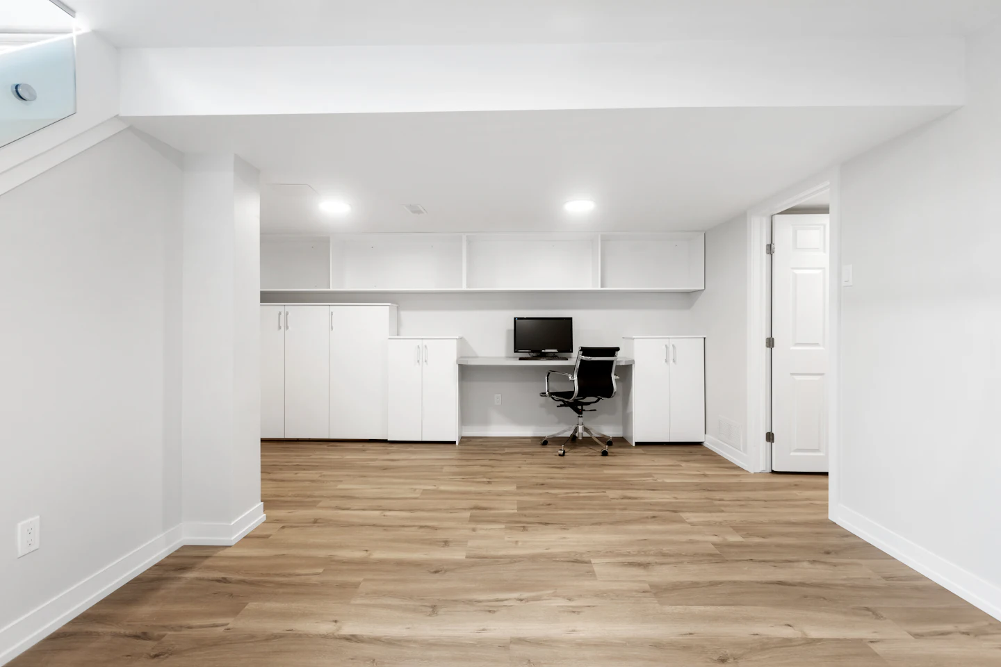 Home office nook with built-in cabinets in a finished basement