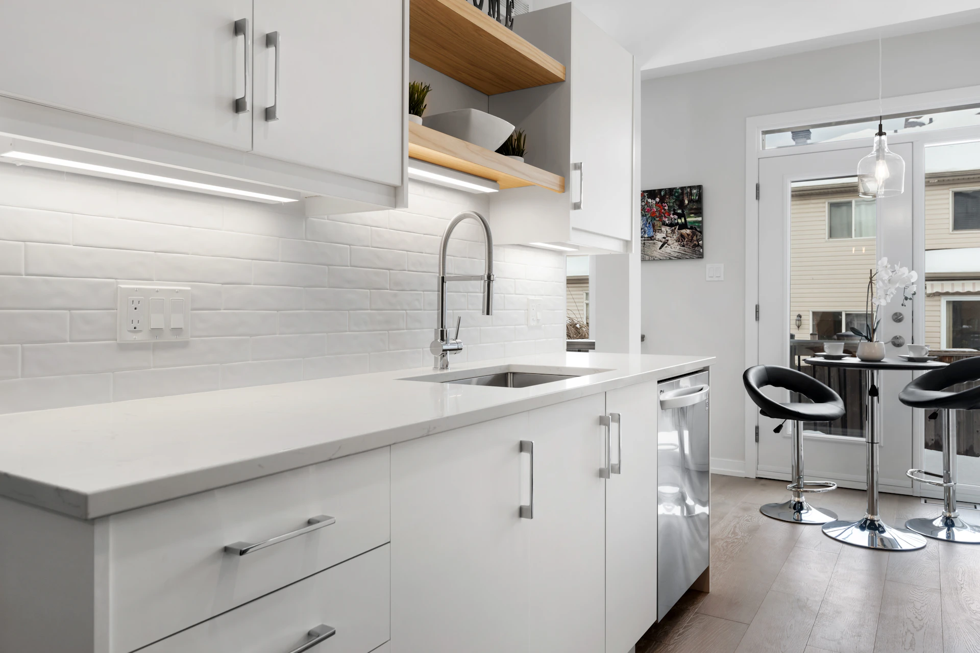 a kitchen with white cabinets and counter tops