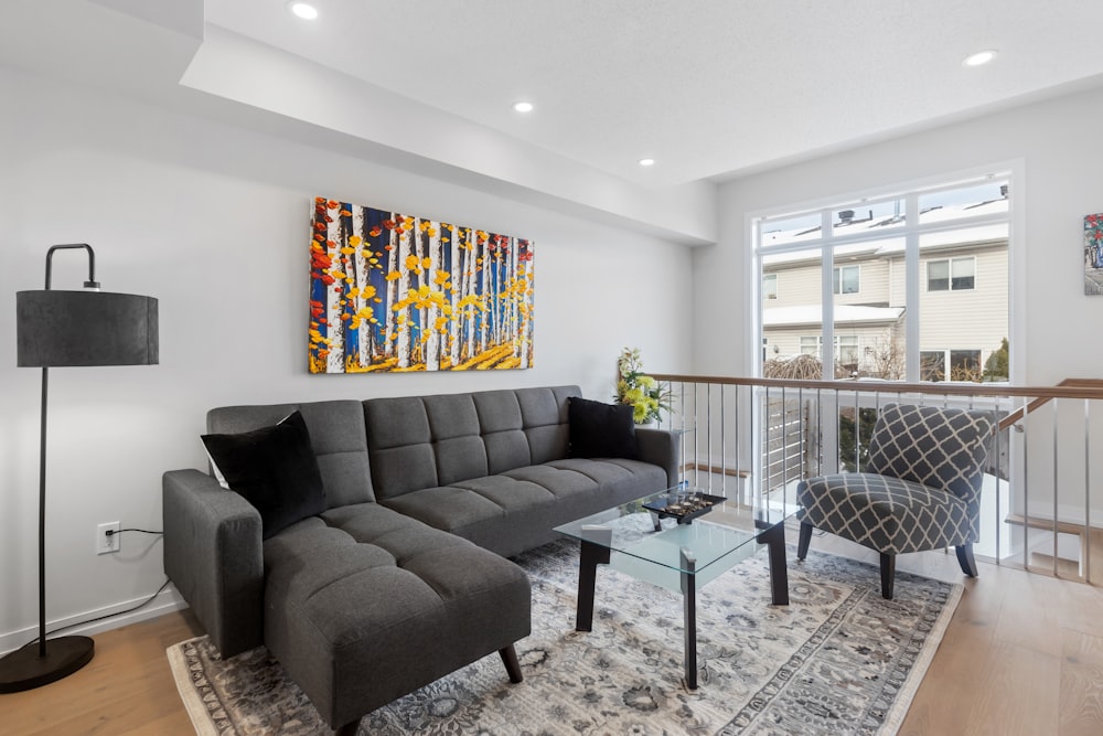 a living room filled with furniture and a painting on the wall