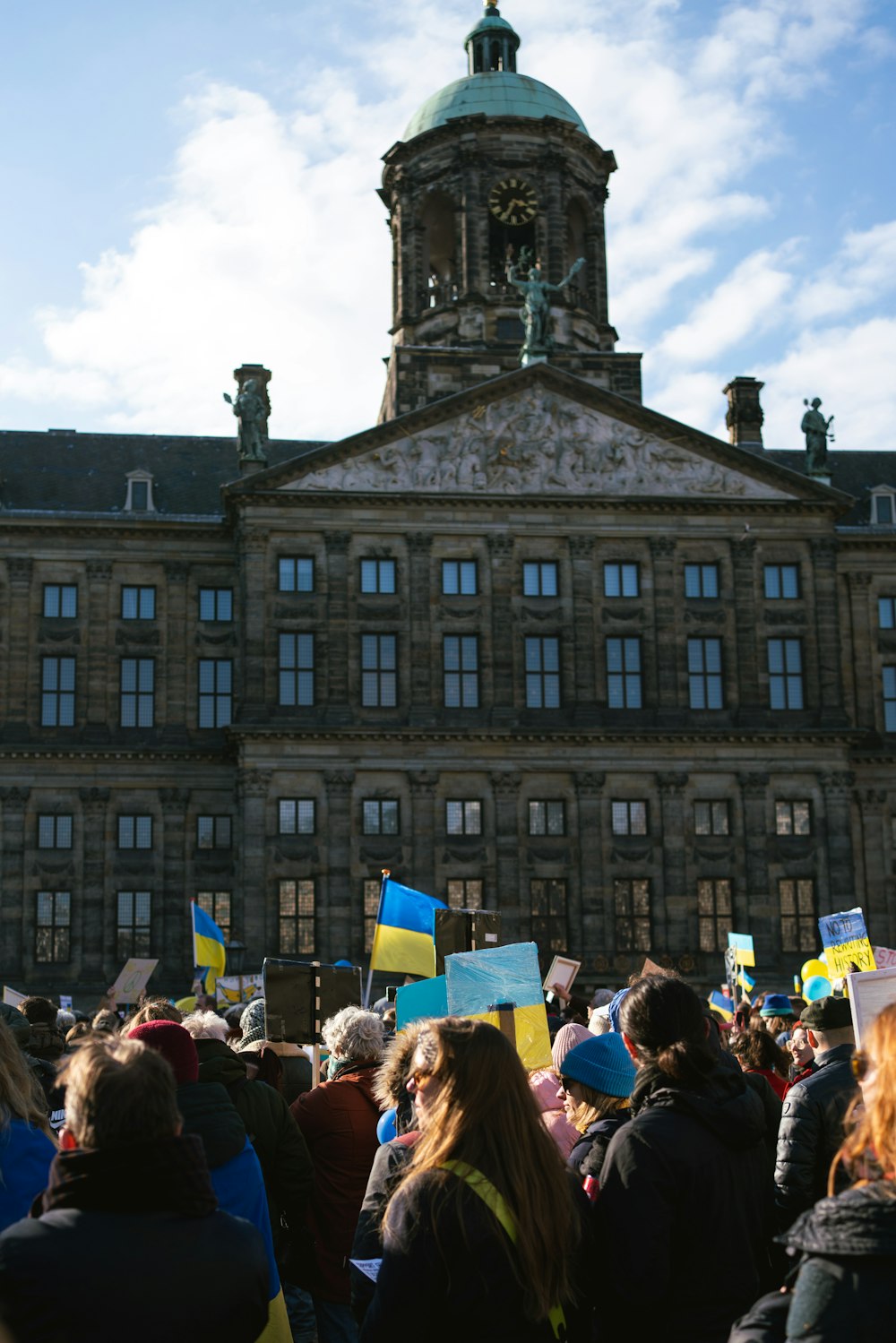 a crowd of people standing in front of a large building