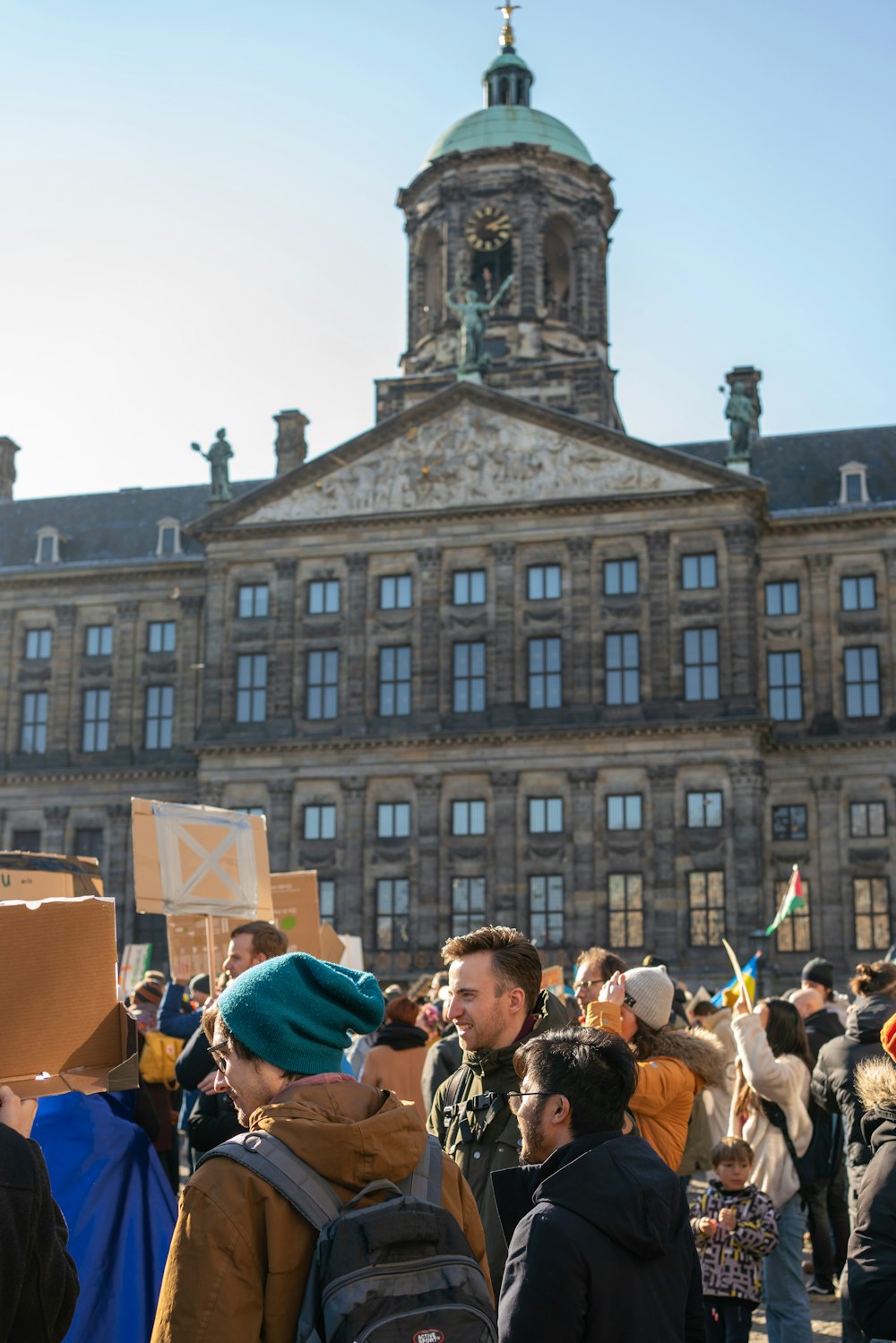 a crowd of people standing in front of a large building