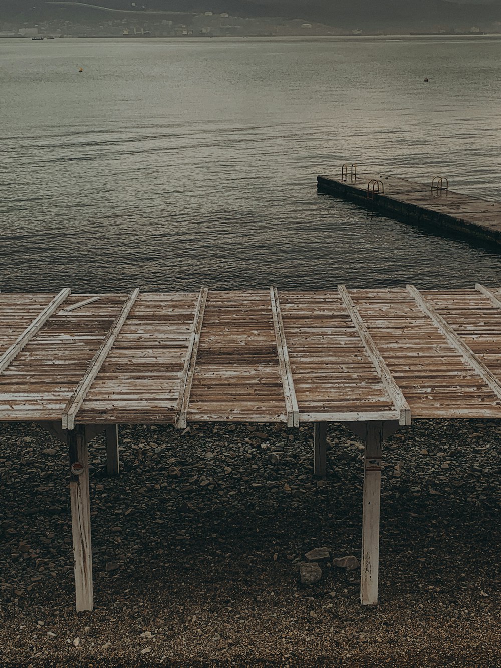 a wooden dock sitting next to a body of water