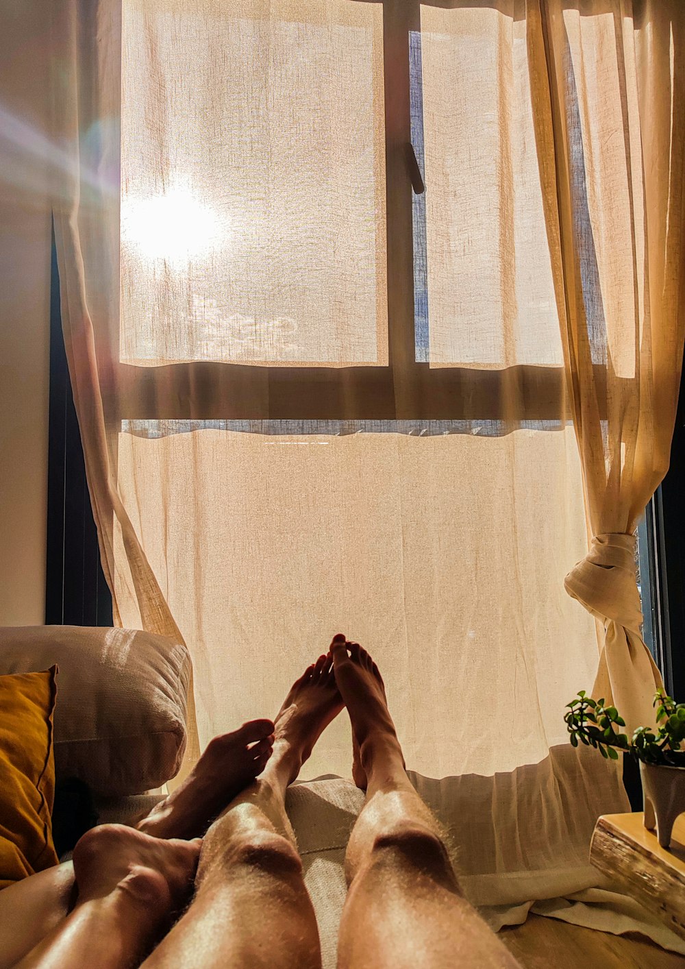 a person laying on a bed with their feet up