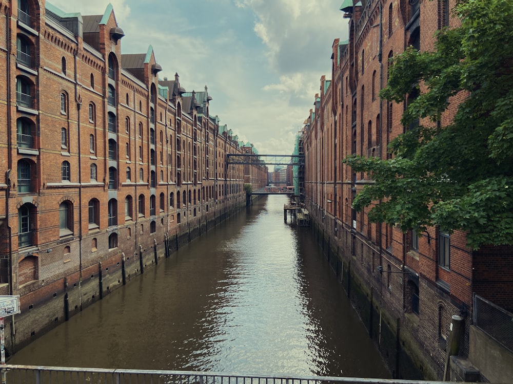 a river running through a city next to tall buildings