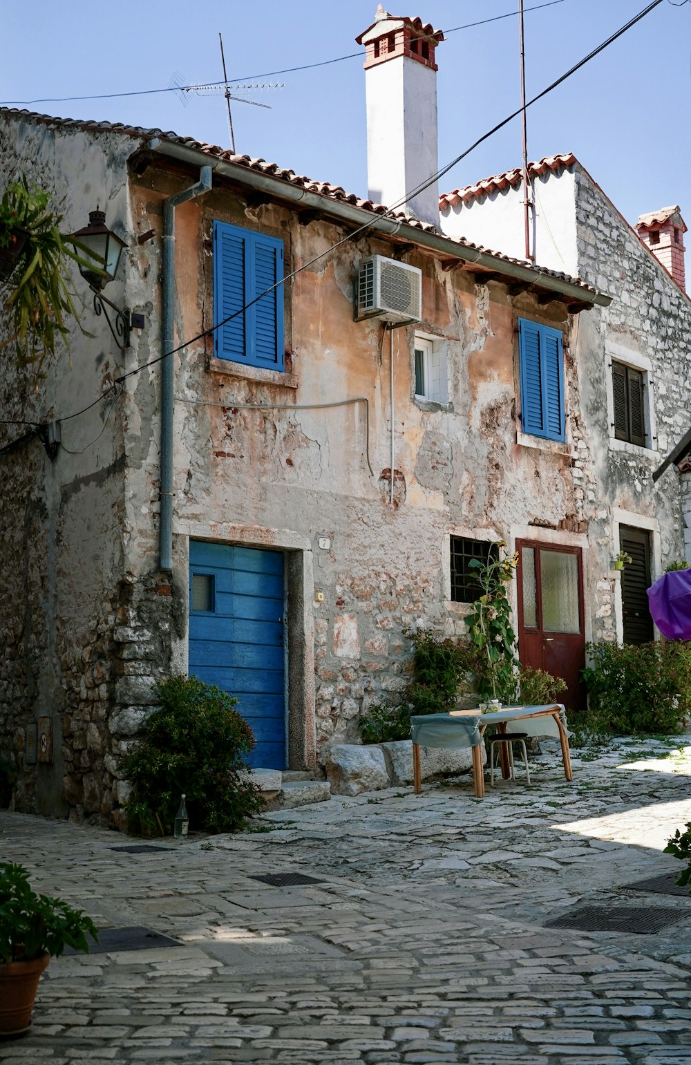 an old building with a blue door and windows