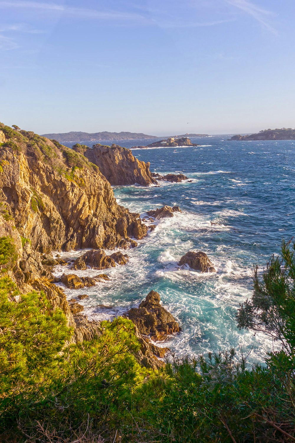 a view of the ocean from the top of a hill