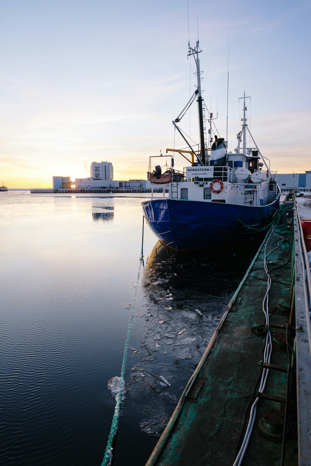 a boat is docked at a dock in the water