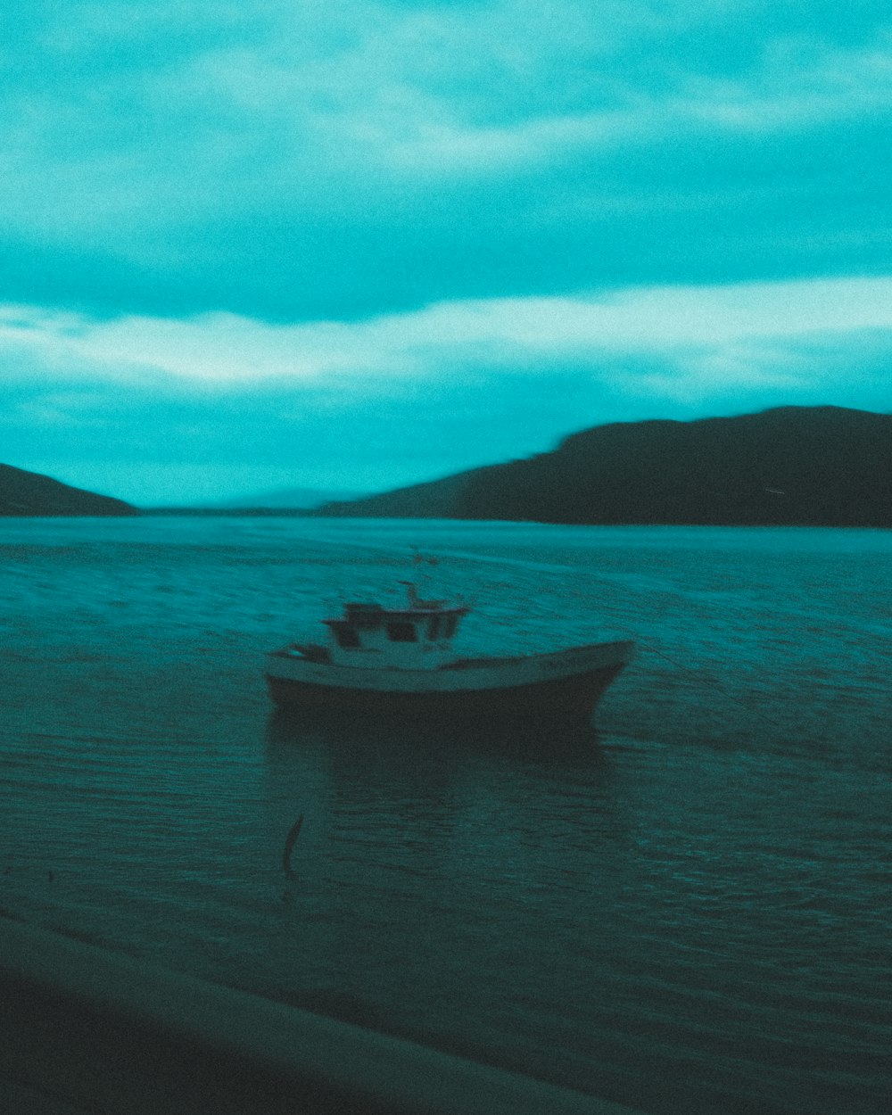 a boat floating on top of a large body of water