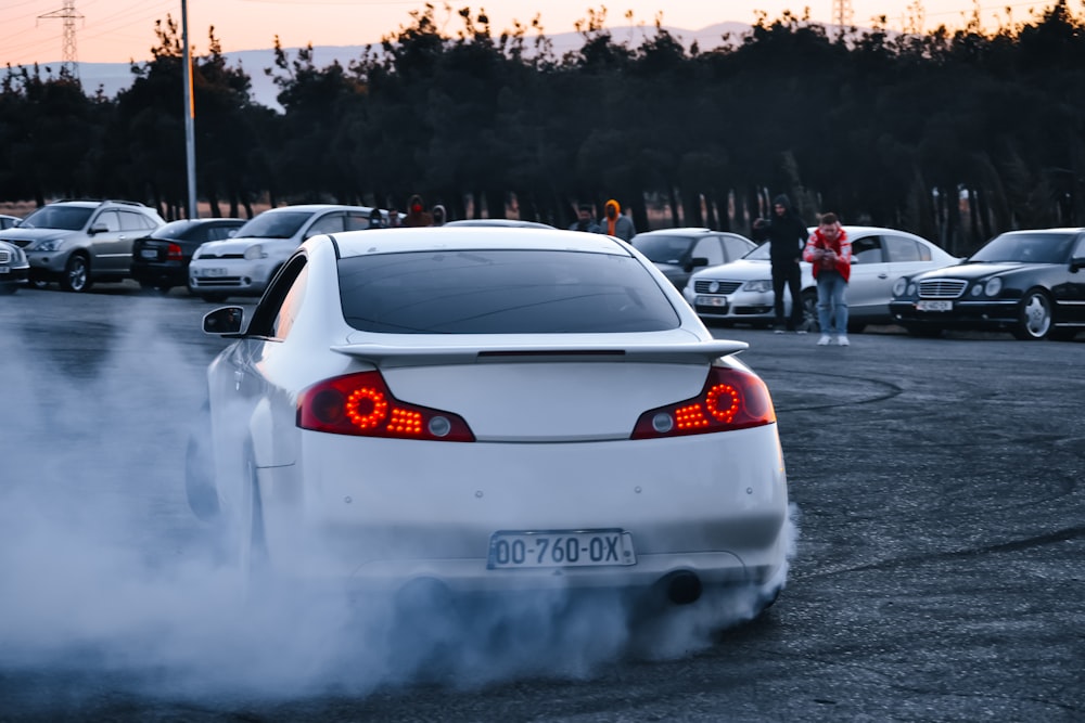 a white car with a lot of smoke coming out of it