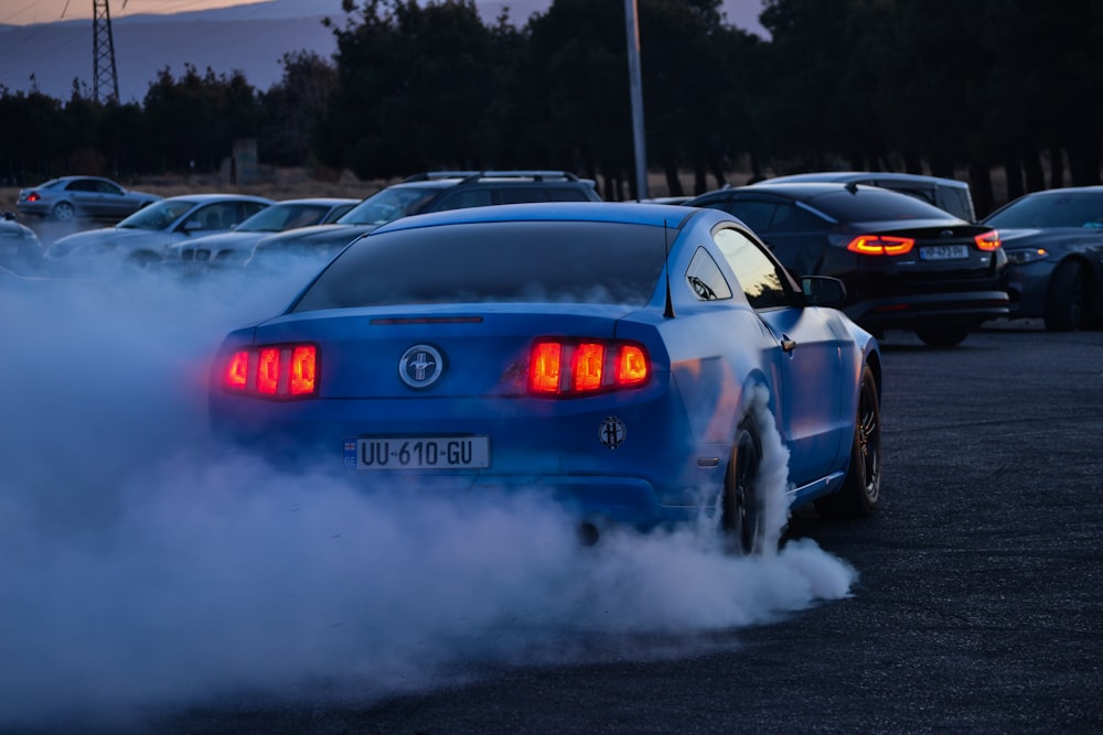 a blue car with a lot of smoke coming out of it