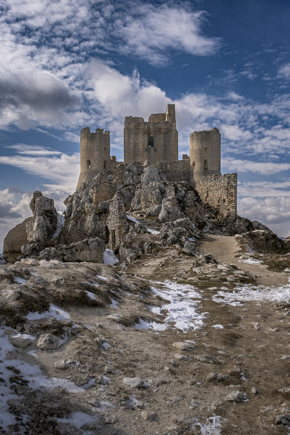 a castle sitting on top of a rocky hill