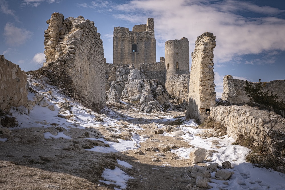 a snow covered path leading to a castle