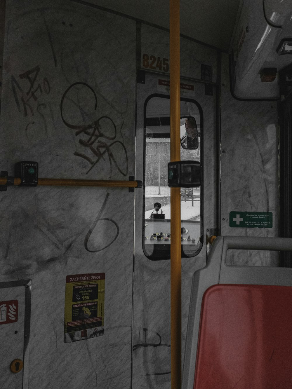 the inside of a bus with graffiti on the walls