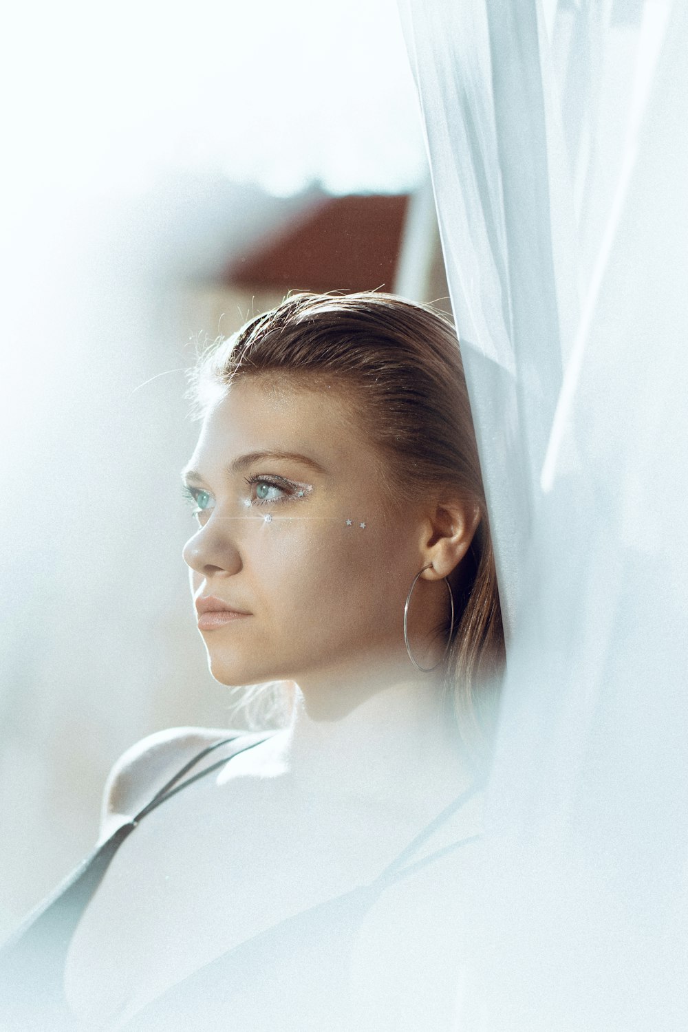 a woman is looking out of a window