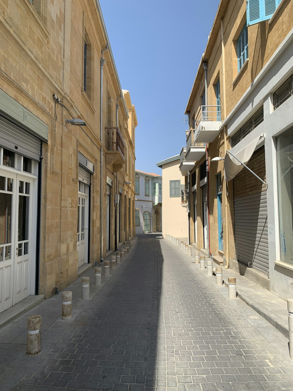 an empty street with a few buildings on both sides