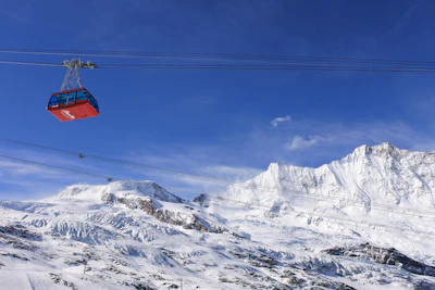 a ski lift going up a snowy mountain
